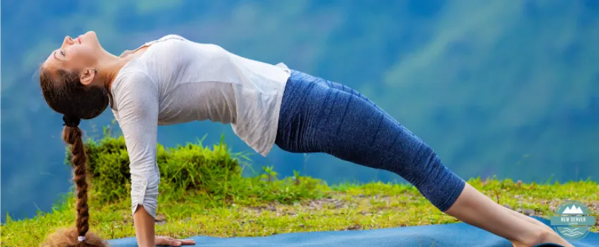 NDL - Woman doing yoga stretches in the mountains